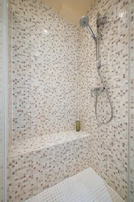 a bathroom with a shower with a tiled wall at Ciel d'Orves - Terrasse Spacieuse- Parking privé in Nice