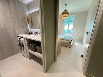 a bathroom with a sink and a washing machine at 3P neuf et climatisé Nice le Port à 9mn de la mer in Nice