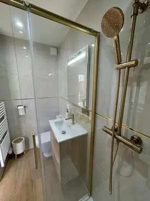 a white bathroom with a shower and a sink at Studio avec jardinet proche mer in Cagnes-sur-Mer