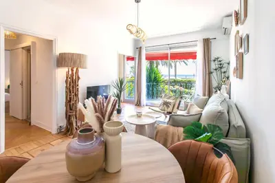 a living room with a table and a couch at L54 1BDR Promenade Sea View AC & Balcony in Nice