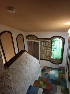 a room with a painting on the wall and a window at Maison dans l'arrière pays niçois entre mer et montagne in Tourrette-Levens
