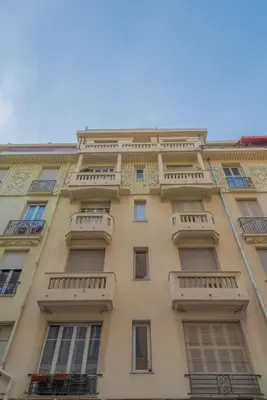 a tall building with balconies on the side of it at Superbe Appartement au Cœur de Nice in Nice