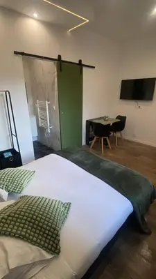a bedroom with a large bed and a table at Studio Californie beach in Nice