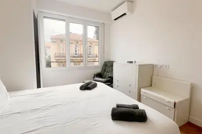a bedroom with a large white bed with two towels on it at Le Villermont - Liberation Centre Ville in Nice