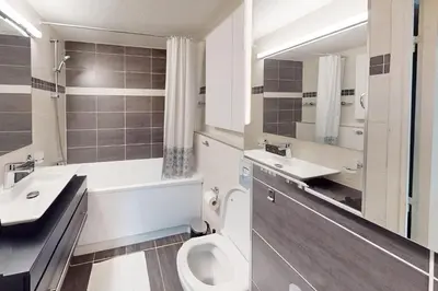a bathroom with a toilet and a sink and a mirror at Cozy Apt with Balcony - 5 min to the Beach in Nice