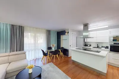 a kitchen and living room with a couch and a table at Cozy Apt with Balcony - 5 min to the Beach in Nice