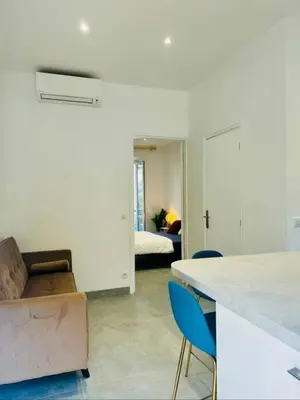 a kitchen and living room with a couch and a bed at LEî in Beaulieu-sur-Mer