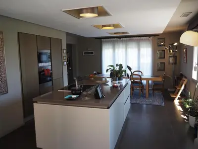 a kitchen with a counter and a dining room at Villa spacieuse, totalement adaptée aux normes PMR in Nice