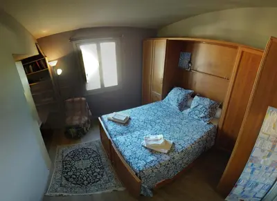 a small bedroom with a bed and a window at Villa spacieuse, totalement adaptée aux normes PMR in Nice