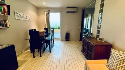 a living room with a table and chairs and a window at Eze flat with terrace sea view and mountain view in Èze