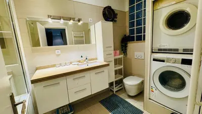 a bathroom with a sink and a washing machine at Eze flat with terrace sea view and mountain view in Èze