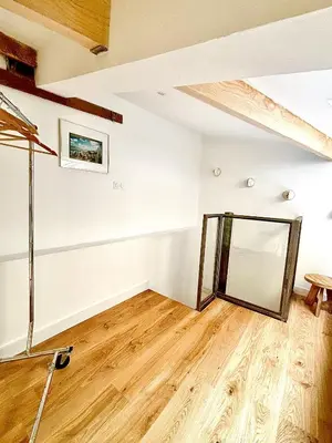 an empty room with a mirror on the wall at Duplex moderne port de Nice in Nice