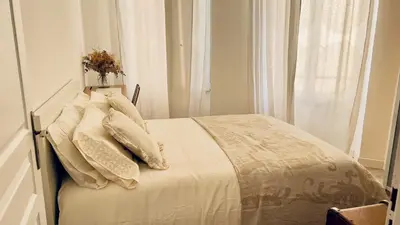 a bedroom with a bed with white sheets and pillows at Shared Duplex Apartment Nice-Port in Nice