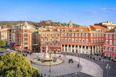 a city square with a fountain in front of buildings at Nestor&Jeeves - KALLISTA - Central - Balcony in Nice