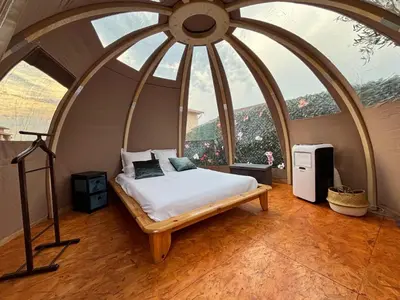 a bed in a room with a large window at Glamping Dôme in Cagnes-sur-Mer