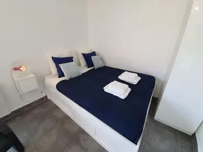 a white bed with blue sheets and towels on it at Ma place au sud Nice 607 in Nice