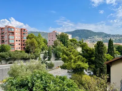 a view of a city with buildings and trees at Spacieux appartement à Nice in Nice