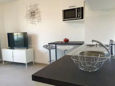 a kitchen with a counter with a sink and a microwave at Ma place au sud Nice 405 in Nice