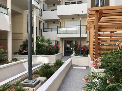 a courtyard of a building with flowers and plants at Ma place au sud Nice 405 in Nice