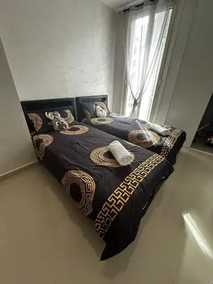a bed with a black and gold bedspread and a window at Sea Front View - FRONT DE MER ET VUE PANORAMIQUE in Nice