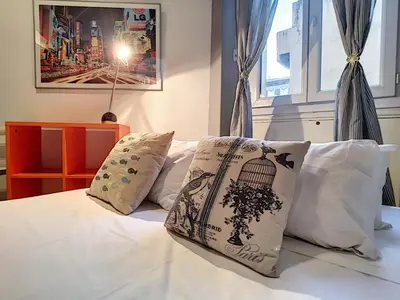 a bedroom with a bed with a bird cage pillow at Nestor&Jeeves - NOE - Central - Close sea - Spacious in Nice