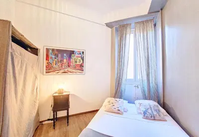 a small bedroom with a bed and a window at Nestor&Jeeves - NOE - Central - Close sea - Spacious in Nice