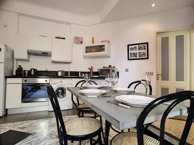 a kitchen with a table and chairs in a kitchen at Nestor&Jeeves - NOE - Central - Close sea - Spacious in Nice