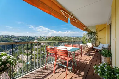 a patio with a table and chairs on a balcony at Nice Renting - ABBAYE - Luxury Penthouse Sea View Pool Tennis Parking in Nice