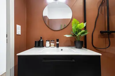 a bathroom with a white sink and a mirror at Shopping et Détente au Centre Ville de Nice ! in Nice