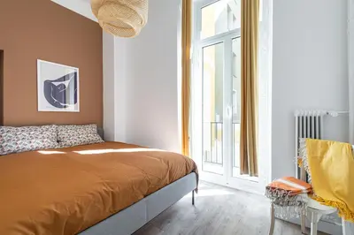 a bedroom with a bed and a large window at Shopping et Détente au Centre Ville de Nice ! in Nice