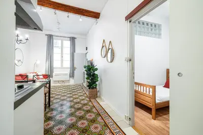 a kitchen and living room with white walls at 2 Bdr with Independent Studio - Old Town in Nice
