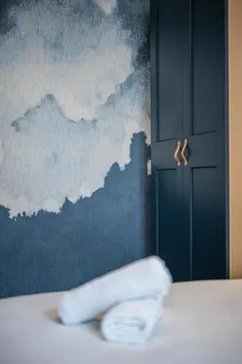 a towel sitting on a bed in front of a wall at La Suite Lascaris PORT of NICE #renovated in Nice