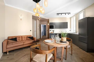 a living room with a table and a couch at La Suite Lascaris PORT of NICE #renovated in Nice
