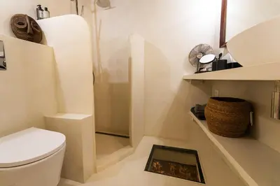 a white bathroom with a toilet and a sink at LA CASETTA DI AZZURRA AP4427 By Riviera Holiday Homes in Villefranche-sur-Mer