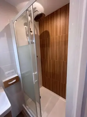 a shower with a glass door in a bathroom at Studio climatisé Bohème Chic in Villefranche-sur-Mer