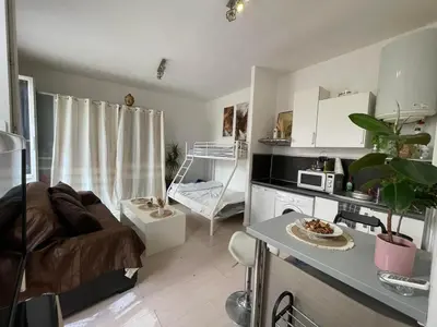 a small living room with a couch and a table at Charmant loft HyperCentre in Nice