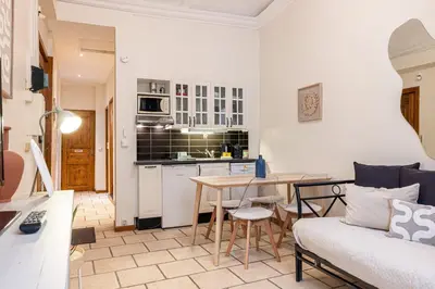 a kitchen and living room with a table and a couch at 2 Bdr Heart Old Town Nice in Nice