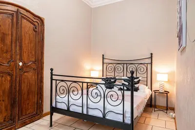 a bedroom with a bed and a wooden cabinet at 2 Bdr Heart Old Town Nice in Nice