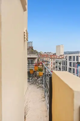 a balcony with tables and chairs on a building at Appartement Gare Nice Ville in Nice