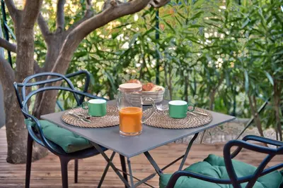 a table with a breakfast of orange juice and bread at Studio avec grande terrasse YourHostHelper in Villefranche-sur-Mer