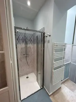 a shower with a glass door in a bathroom at Rossetti Rosa Vieux Nice 2 bed in Nice