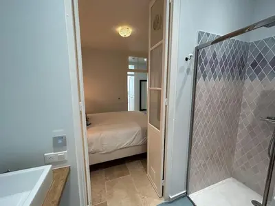 a bathroom with a shower and a bedroom with a bed at Rossetti Rosa Vieux Nice 2 bed in Nice