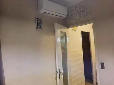 a room with a ceiling fan and a door at 2 pieces pour 4 personnes proche tram in Nice
