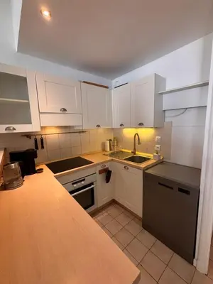 a kitchen with a table and chairs in a room at Heart of the Old City - Nice in Nice