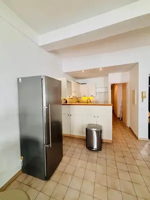a kitchen with a stainless steel refrigerator and a tile floor at Heart of the Old City - Nice in Nice