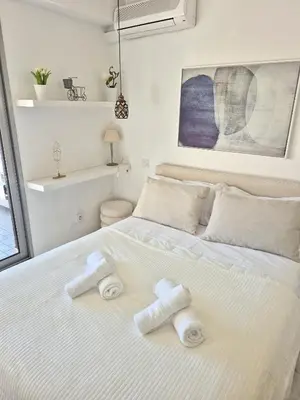 a bedroom with a white bed with towels on it at Superbe Appartement Luxueux Spacieux 50 m2 Port Nice in Nice