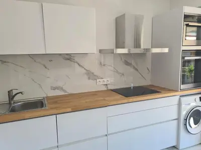 a white kitchen with a sink and a stove at Superbe Appartement Luxueux Spacieux 50 m2 Port Nice in Nice