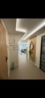 a hallway of a living room with a clock on the wall at APPARTEMENt COSY in Nice