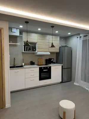 a kitchen with white cabinets and a stove top oven at APPARTEMENt COSY in Nice