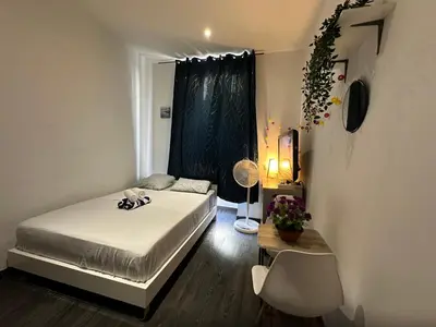 a small bedroom with a bed and a window at Delight room 1st door in Nice